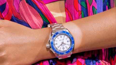 Omega O-Megasteel Seamaster Planet Ocean Ultra Deep 6,000M bracelet watch, £10,350. Isabel Marant silk Alsaw dress, £1,100, and bikini top, £135