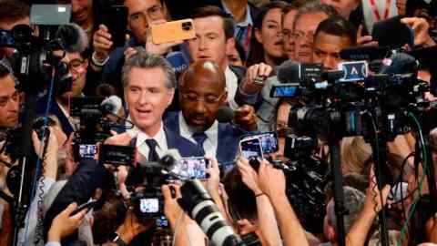 California governor Gavin Newsom surrounded by media