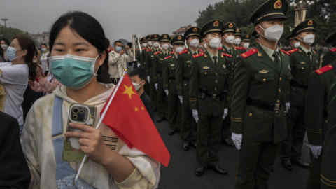 People’s Armed Police march by after the flag-raising ceremony to mark China’s National Day last week