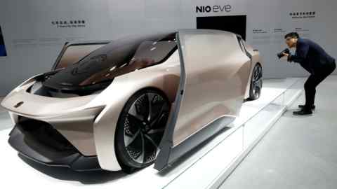 A visitor looks at the Nio Eve concept car displayed during the Shanghai Auto Show