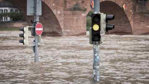 Traffic lights poking out of water on flooded street