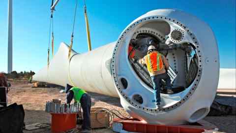 Employees  working on the construction of a wind turbine