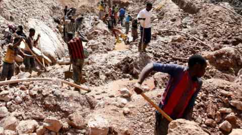 Labourers work at an open shaft of a mine near Rubaya in the Democratic Republic of Congo