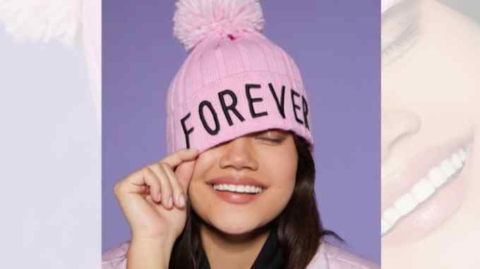 woman wearing a pink beanie with the word ‘Forever’ printed on it