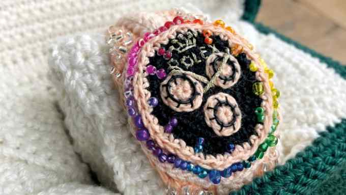 A crocheted Rolex watch inside its crocheted box