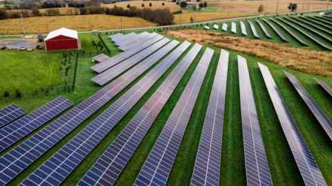 Farmland is seen with rows of solar panels