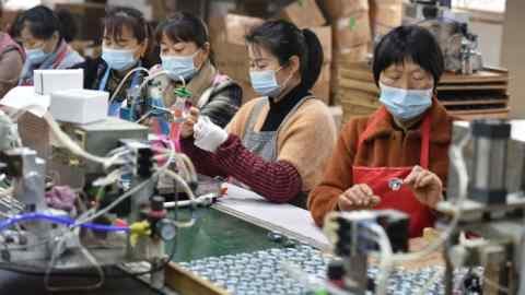 Employees on an assembly line producing speakers at a factory in Linquan county, Fuyang, China