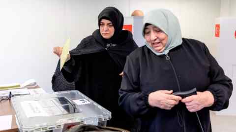 Two women casting their ballots