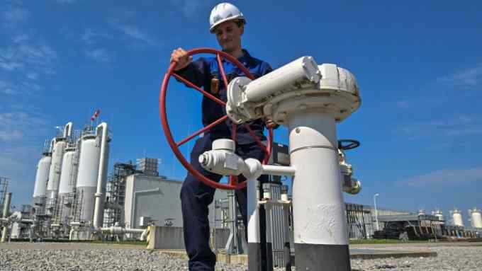 a worker at a gas hub operating equipment