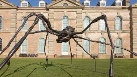 7-metre spider sculpture by Louise Bourgeois on the lawn in front of Compton Verney, a large 18th-century pale stone house