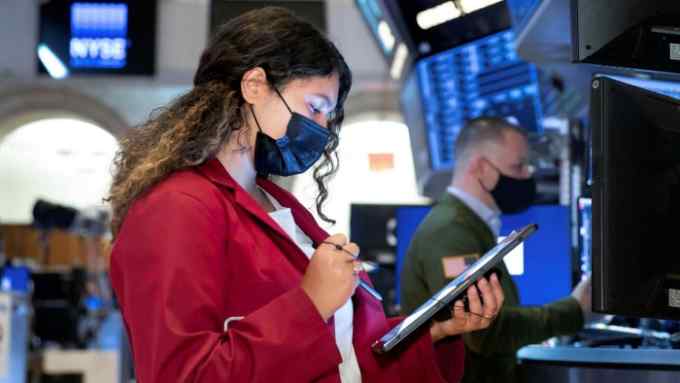 In this photo provided by the New York Stock Exchange, trader Ashley Lara works on the floor