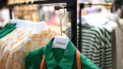 Clothes are displayed on hangers at a Shein pop-up store