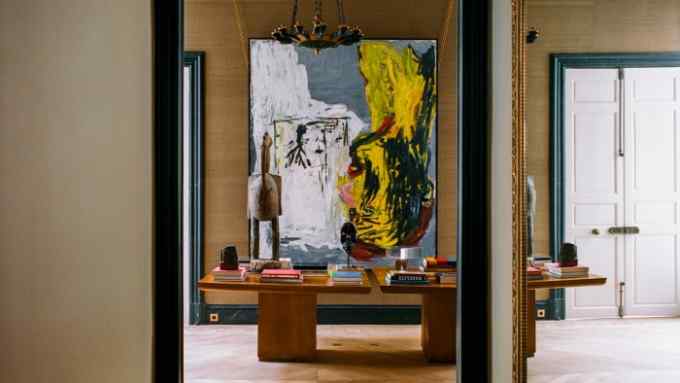 The first-floor reception of Gillier’s home, with a pair of made-to-measure dining tables by Festen. On the table stands a late-19th-century Calao Senoufo statue from the Côte d’Ivoire; on the wall is Kopf in der Sonne, 1982, by Georg Baselitz