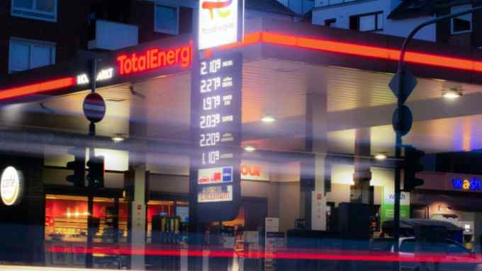 A brightly lit German petrol station at night-time