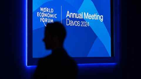 A man is seen in silhouette in the Congress center on the opening of the annual meeting of the World Economic Forum (WEF) in Davos on January 15, 2024