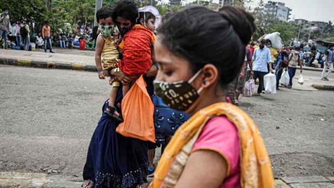 Escape route: migrant workers queue at a railway station to leave Mumbai before a lockdown is imposed