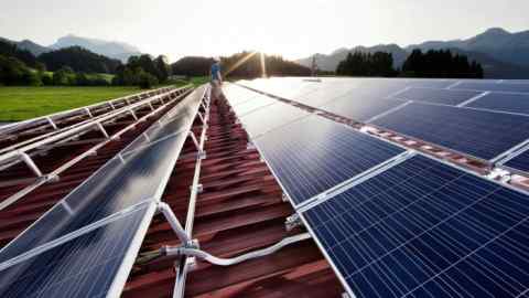 A technician inspects a solar energy plant in Tyrol