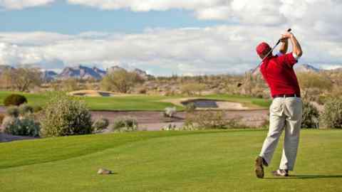 A golfer on the tee on a desert golf course in Mesa, Arizona