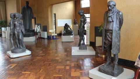 An array of bronze statues inside a studio