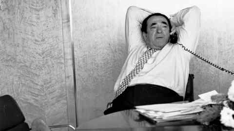 Robert Maxwell reclining at his desk at the Mirror while on the telephone in 1987