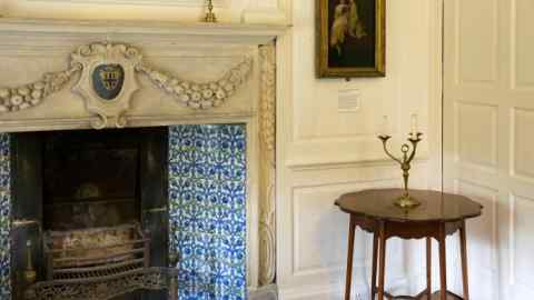 Blue-tiled Victorian fireplace at Kelmscott Manor, William Morris’s Cotswolds retreat