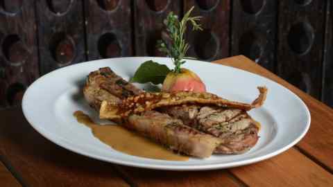 Grilled pork chop with Slow-roasted Windsor apple and cider sauce from Julian marshall’s Bleeding Heart Bistro