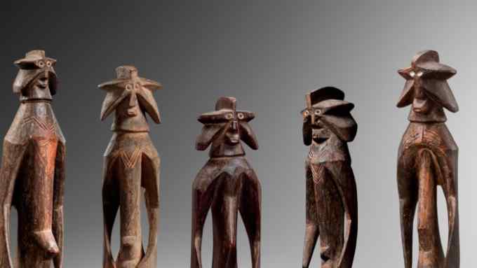 Long thin wooden sculptures with star-shaped heads