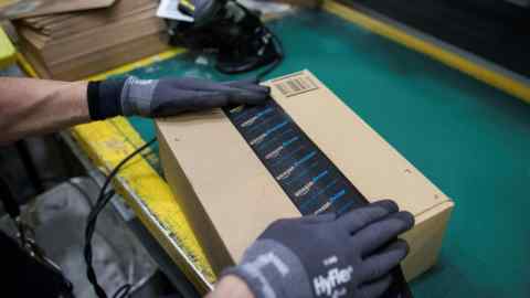 An Amazon worker assembles a package
