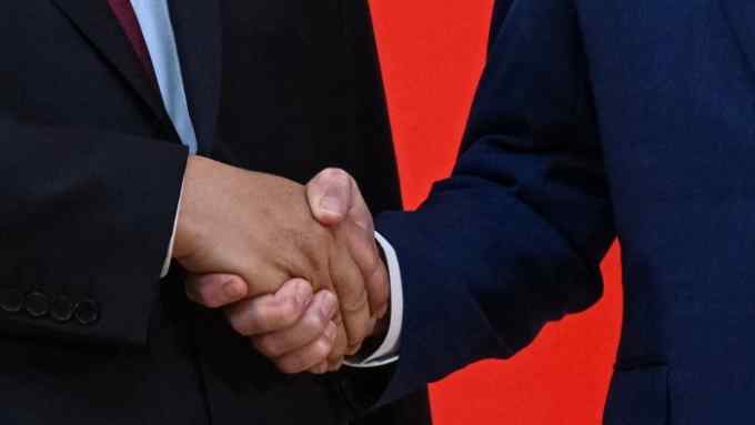 close-up shot of two people shaking hands