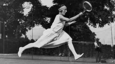A black and white photo of French player Suzanne Lenglen competing at Wimbledon in 1926