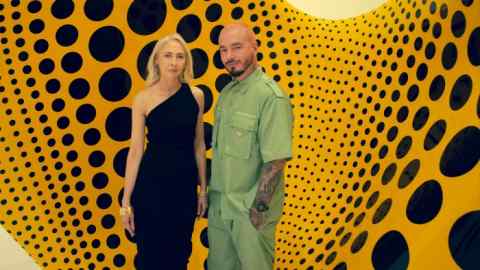 Melissa Chiu and J Balvin in front of Aspiring to Pumpkin’s Love, the Love in My Heart, 2023, by Yayoi Kusama, at David Zwirner, New York