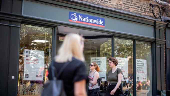 Shoppers walk past a branch of Nationwide building society in the centre of York.