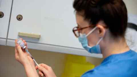 A nurse prepares a dose of Moderna’s Covid vaccine