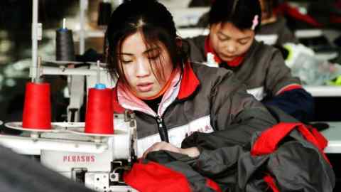 Chinese workers prepare an export order at a clothing factory in Suzhou