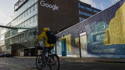A cyclist passes by Google’s European headquarters in Dublin, Ireland