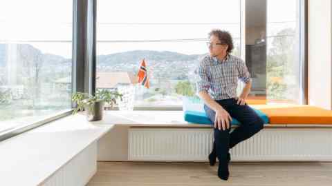 Henning Kongshavn Frønsdal sits by a panoramic window in Villa Sval