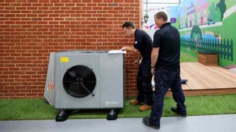 Engineers work on installing an Ecoforest heat pump at Octopus Energy’s training centre in Slough, UK
