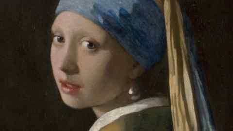 A painting depicts a woman wearing a headscarf and a pearl earring, looking over her shoulder