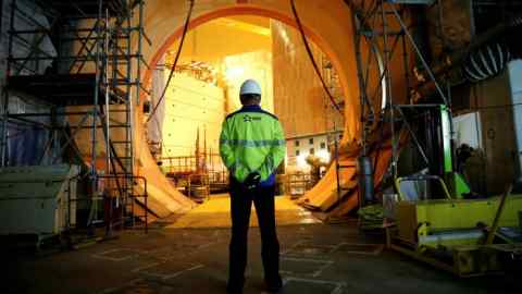 An EDF worker is seen on the construction site of the third-generation European Pressurised Water nuclear reactor